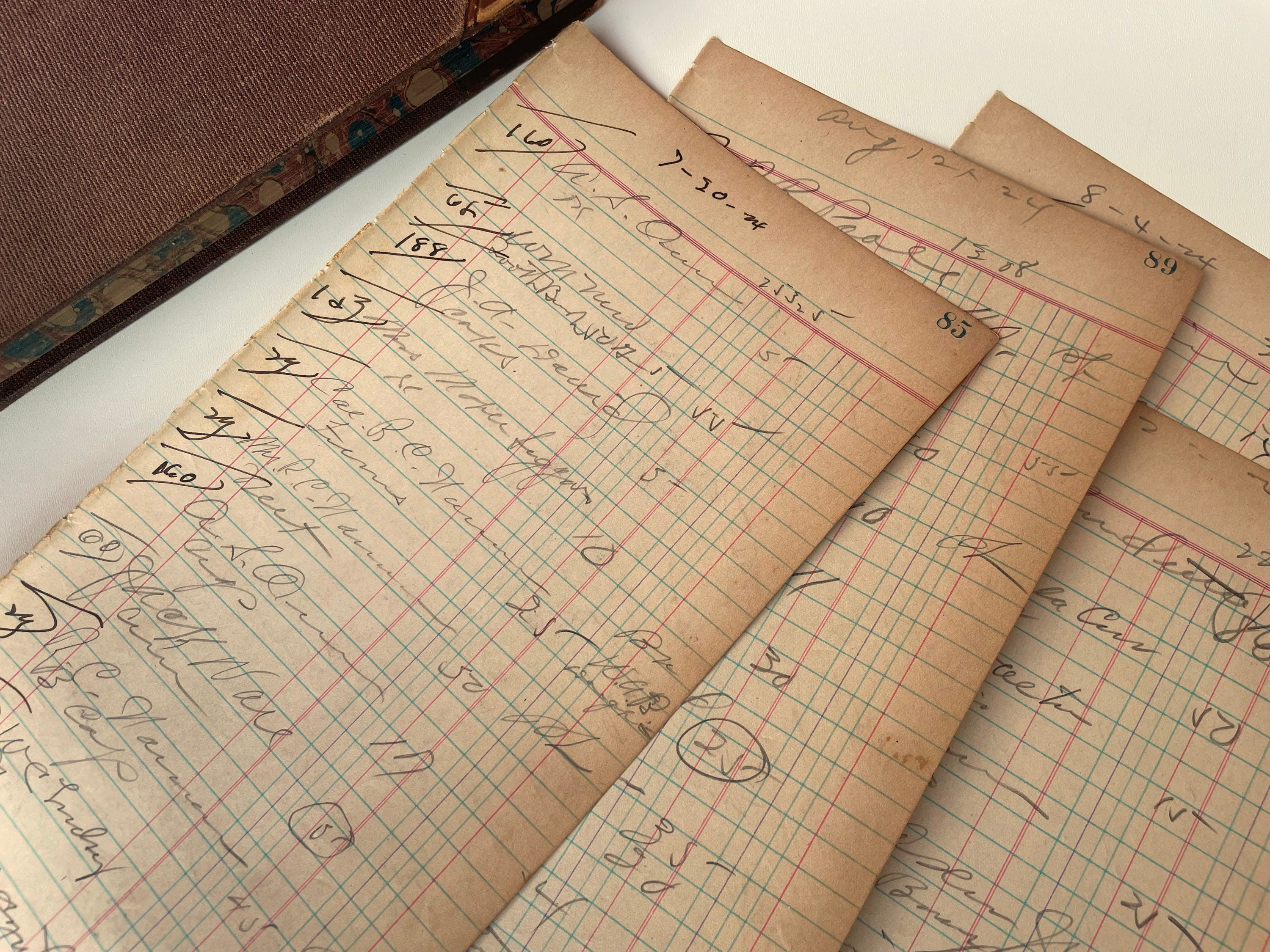 Vintage handwritten accounting ledger pages with warm tones